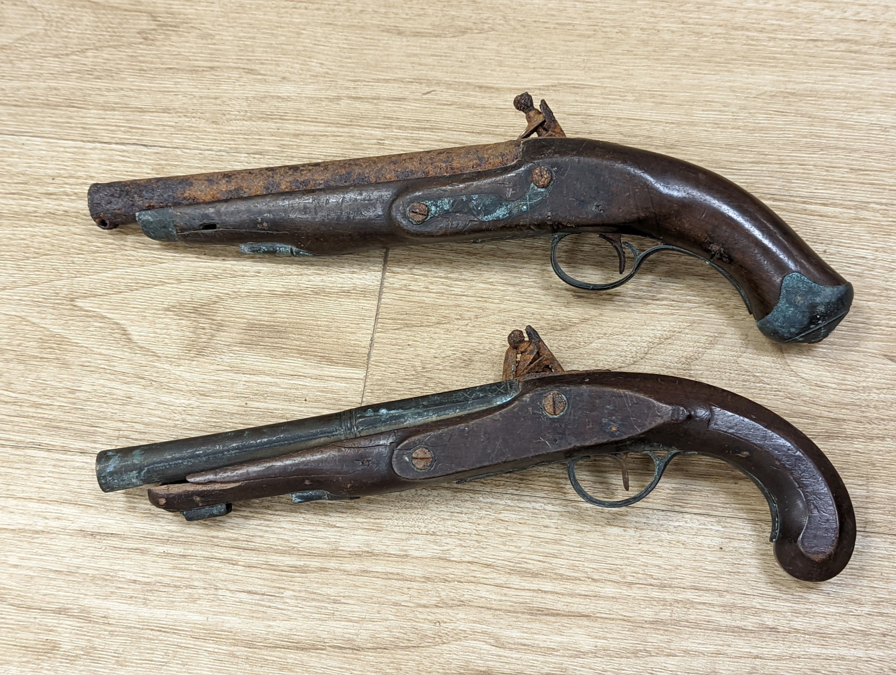 Two 19th century flintlock pistols and a pocket pistol, largest 40 cms long.